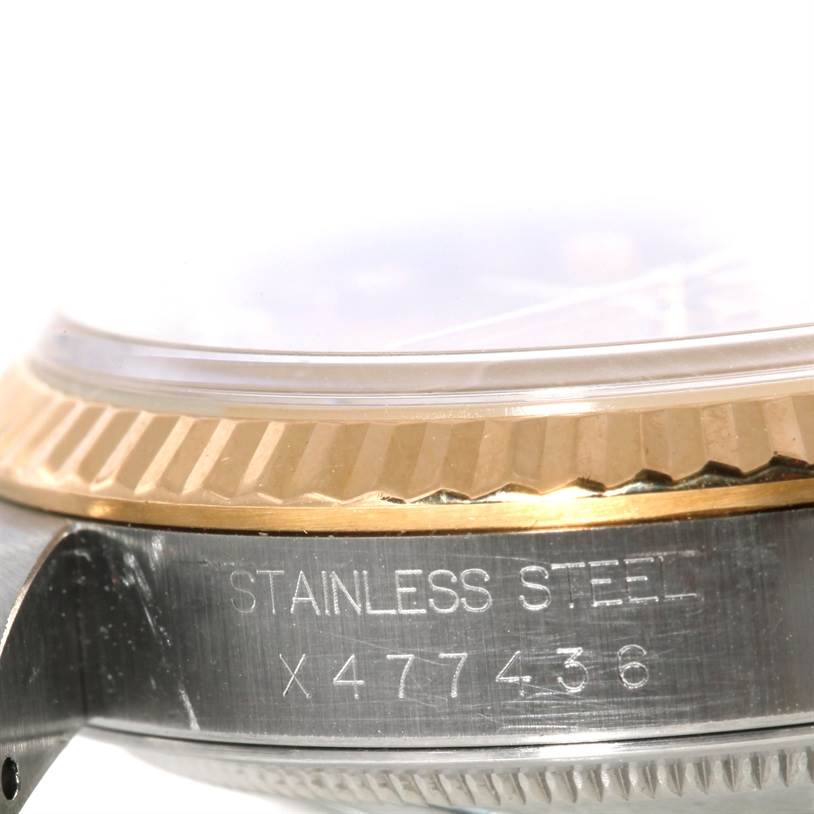 This close-up image of the Rolex Datejust 16233 Men
s Steel and Gold (two tone) Champagne Dial 16233 Men
s Steel and Gold (two tone) Champagne Dial watch shows the stainless steel case and part of the fluted bezel.