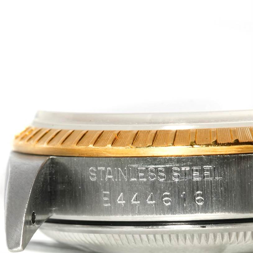 This image shows a close-up of the side of a Rolex Datejust 15223 Men's Steel and Gold (two tone) Black Dial 15223 Men's Steel and Gold (two tone) Black Dial watch, highlighting the stainless steel casing and serial number.