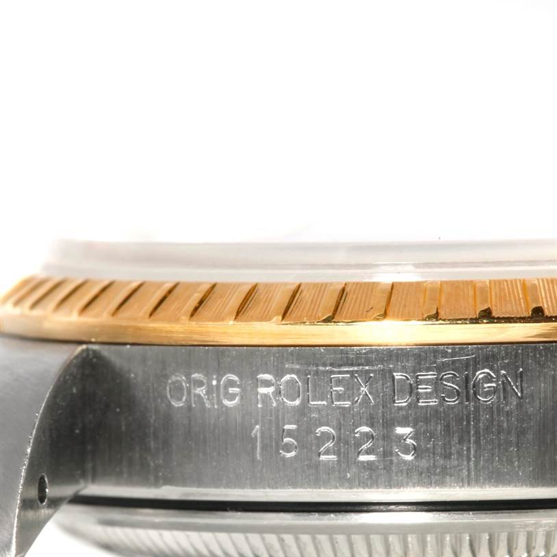 This close-up image showcases the side view of the case and fluted bezel of a Rolex Datejust 15223 Men's Steel and Gold (two tone) Black Dial 15223 Men's Steel and Gold (two tone) Black Dial model 15223.
