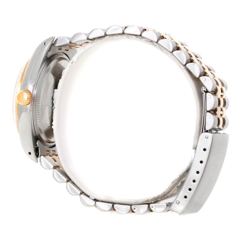 This side angle of the Rolex Datejust 15223 Men's Steel and Gold (two tone) Black Dial 15223 Men's Steel and Gold (two tone) Black Dial model shows the watch case and part of the two-tone bracelet.