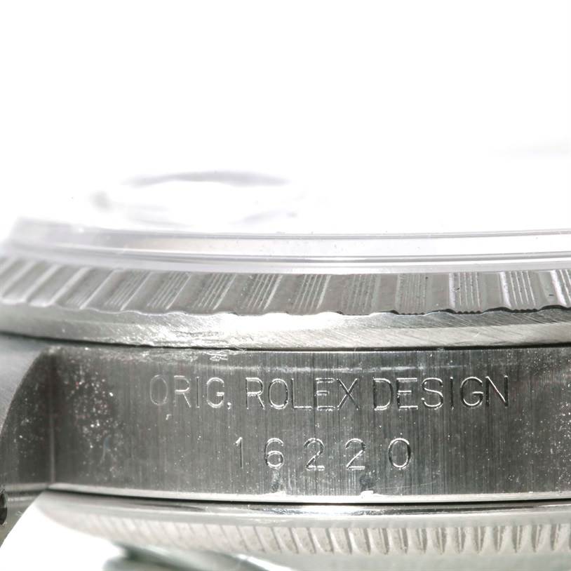 This image shows a close-up side view of the engraved case of a Rolex Datejust 16220 Men's Stainless Steel Silver Dial 16220 Men's Stainless Steel Silver Dial model 16220.