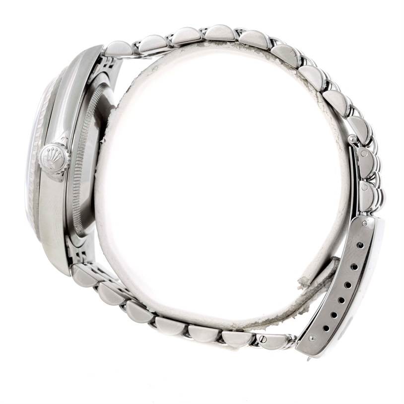 This side view of the Rolex Datejust 16220 Men's Stainless Steel Silver Dial 16220 Men's Stainless Steel Silver Dial watch shows the crown, case, and bracelet links.