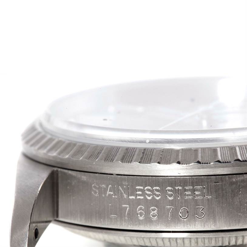 The image shows a close-up of the side view of the Rolex Datejust 16220 Men
s Stainless Steel Grey Dial 16220 Men
s Stainless Steel Grey Dial watch, focusing on the stainless steel casing and model number.