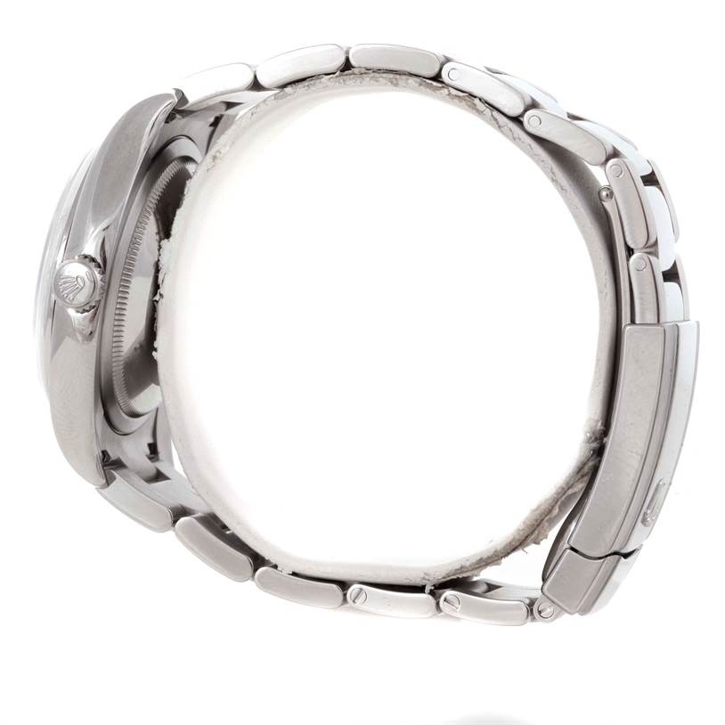 The image shows the side view of a Rolex Datejust 116200 Men's Stainless Steel Silver Dial 116200 Men's Stainless Steel Silver Dial watch, highlighting its crown, case, and bracelet.