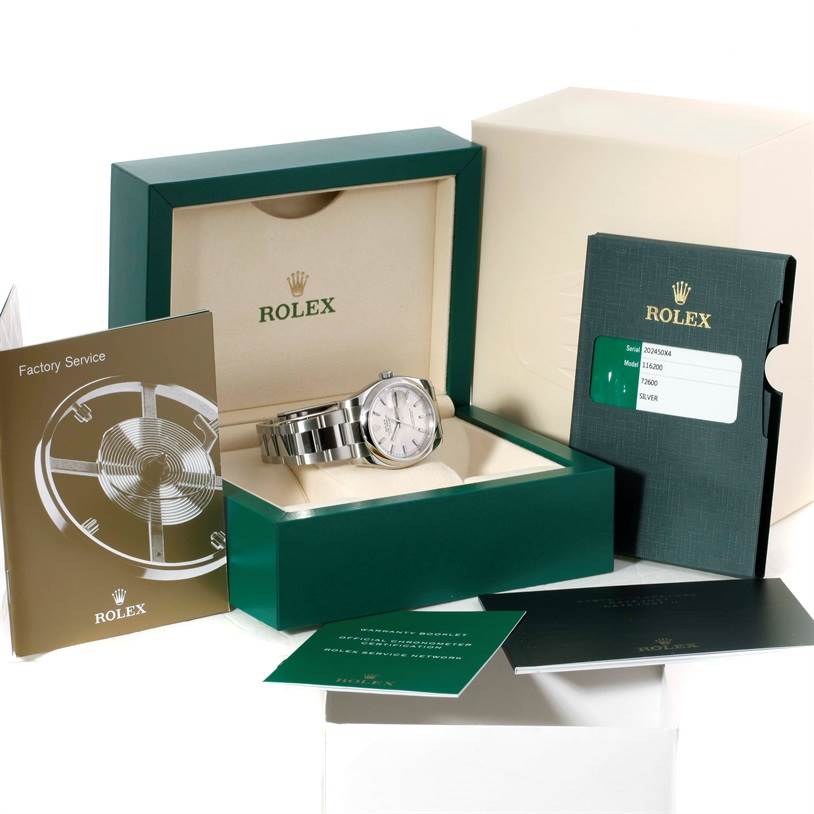 The Rolex Datejust 116200 Men's Stainless Steel Silver Dial 116200 Men's Stainless Steel Silver Dial watch is displayed in its box along with accompanying booklets and warranty card.