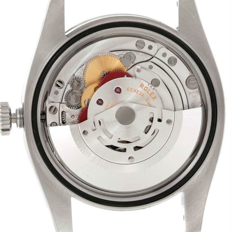 This image shows the internal mechanism of a Rolex Datejust 116200 Men's Stainless Steel Silver Dial 116200 Men's Stainless Steel Silver Dial watch from the back angle, revealing gears and the movement components.