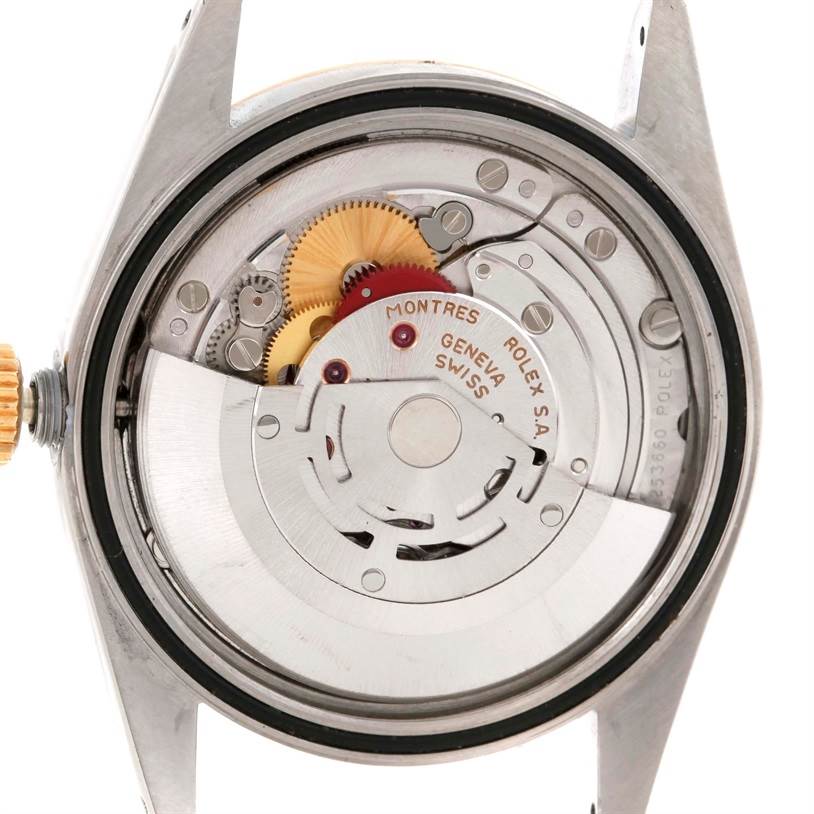 This image shows the Datejust model by Rolex from the back, revealing its internal mechanical movement components.