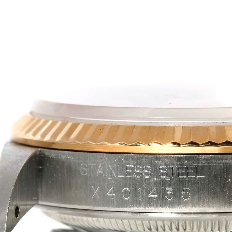 This image shows a close-up side view of the bezel and case of a Rolex Datejust 16233 Men's Steel and Gold (two tone) Champagne Dial 16233 Men's Steel and Gold (two tone) Champagne Dial watch, displaying its stainless steel and gold components.