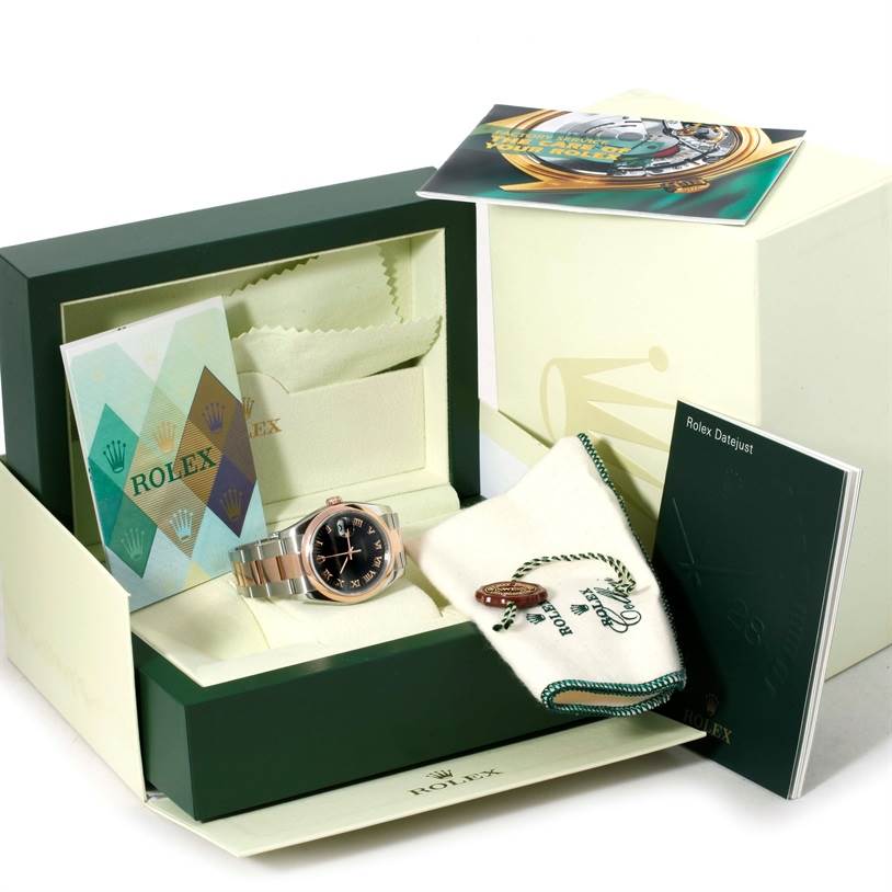 This image shows a Rolex Datejust 116201 Men
s Steel and Gold (two tone) Black Dial 116201 Men
s Steel and Gold (two tone) Black Dial watch with its original box, warranty card, cleaning cloth, booklet, and tags from a front angle.