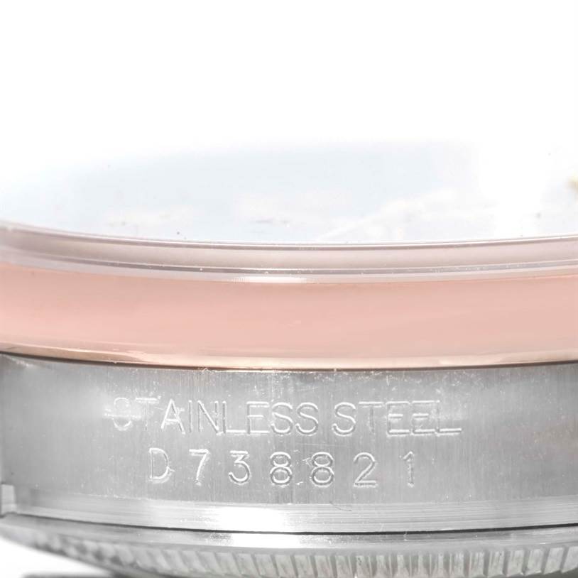 This image shows a close-up of the side of a Rolex Datejust 116201 Men
s Steel and Gold (two tone) Black Dial 116201 Men
s Steel and Gold (two tone) Black Dial watch, highlighting the stainless steel material and serial number.