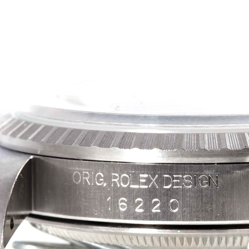 This image shows a close-up of the engraved side of the case of a Rolex Datejust 16220 Men
s Stainless Steel Black Dial 16220 Men
s Stainless Steel Black Dial watch, model 16220.