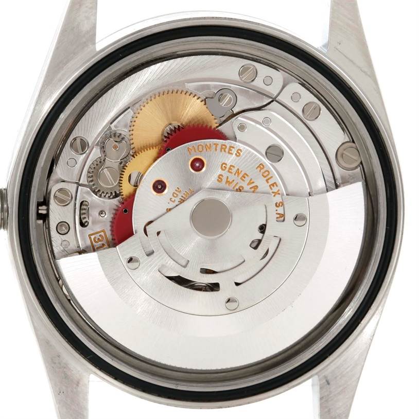 The image shows the back view of a Rolex Datejust 16220 Men
s Stainless Steel Black Dial 16220 Men
s Stainless Steel Black Dial watch, highlighting its internal mechanical movement.