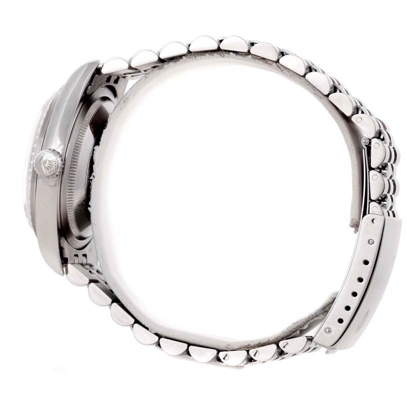 The image shows a side view of a Rolex Datejust 16220 Men
s Stainless Steel Black Dial 16220 Men
s Stainless Steel Black Dial watch, highlighting its case, crown, and bracelet clasp.