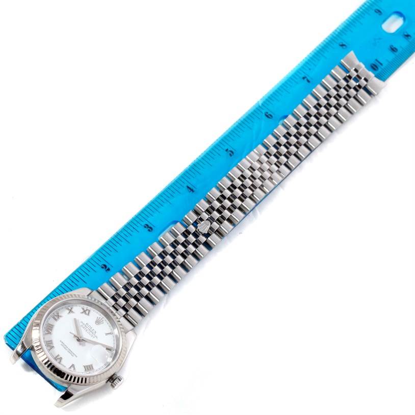 The image shows a Rolex Datejust 116234 Women's Stainless Steel White Dial 116234 Women's Stainless Steel White Dial watch laid flat next to a blue ruler for measurement.