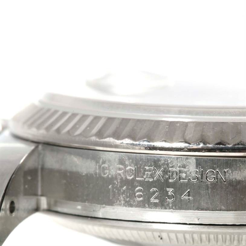 This image shows a close-up of the side of a Rolex Datejust 116234 Women's Stainless Steel White Dial 116234 Women's Stainless Steel White Dial model, focusing on the bezel and case with engraved markings.