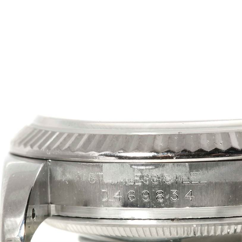 This image shows a side view of the stainless steel case and bezel of a Rolex Datejust 116234 Women's Stainless Steel White Dial 116234 Women's Stainless Steel White Dial watch with part of the serial number visible.