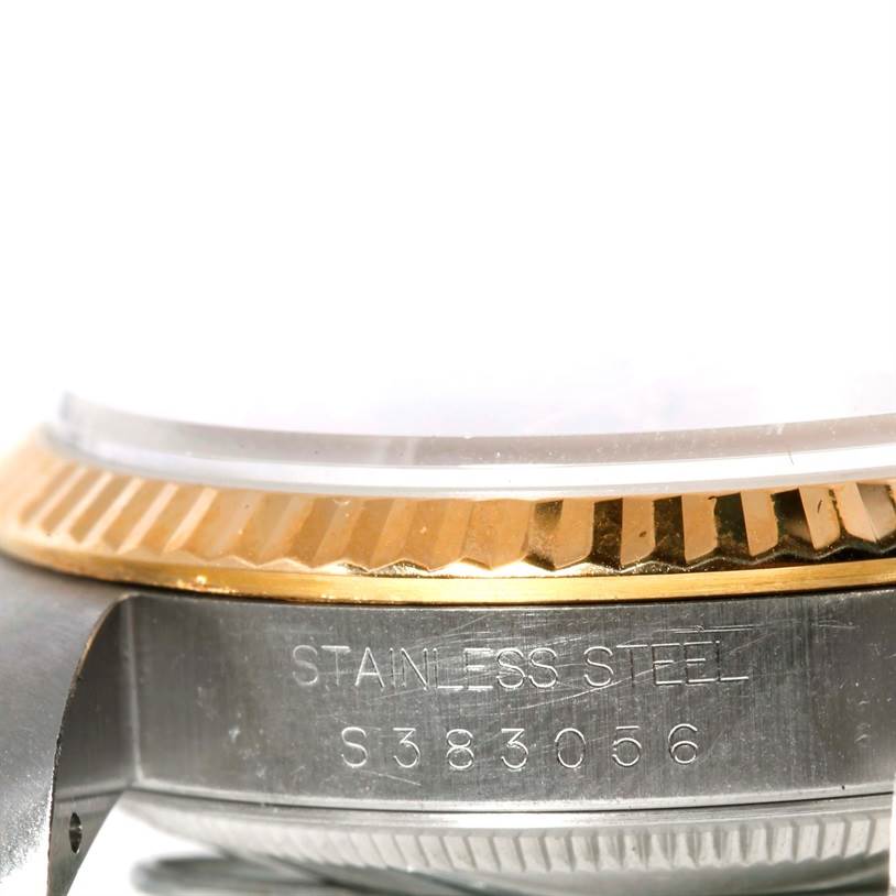 The image shows a close-up side angle of the Rolex Datejust 16233 Men's Steel and Gold (two tone) Champagne Dial 16233 Men's Steel and Gold (two tone) Champagne Dial's bezel, serial number, and part of its case.