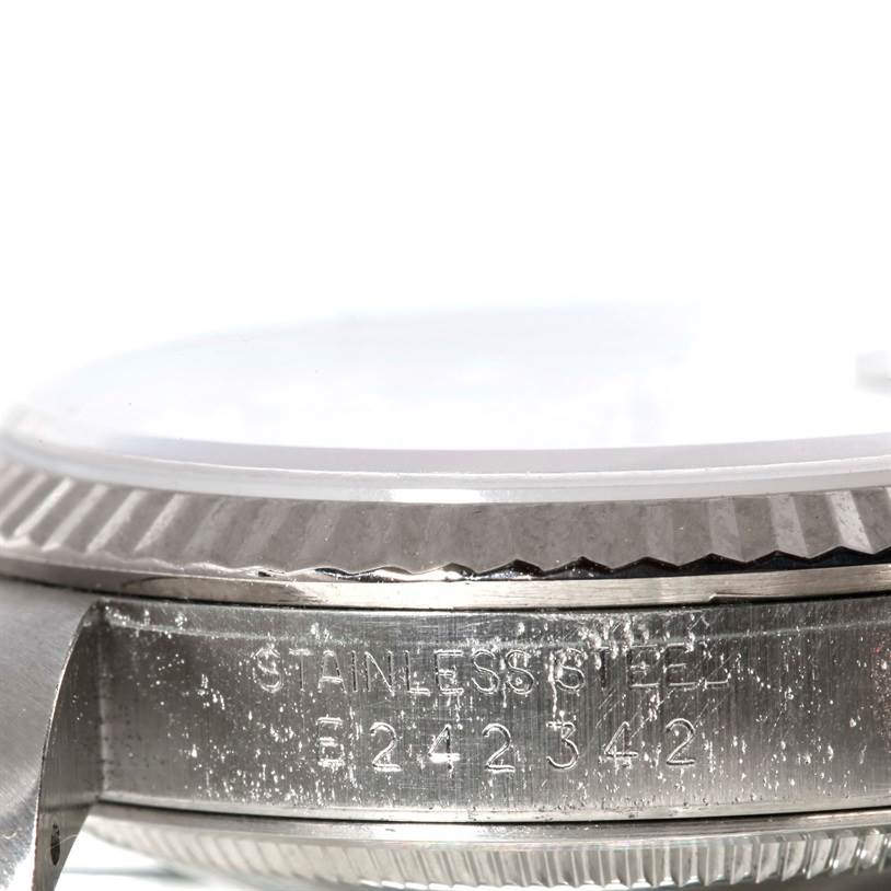 This close-up image shows the edge of the bezel and serial number engraving on a Rolex Datejust 16234 Men's Stainless Steel Silver Dial 16234 Men's Stainless Steel Silver Dial watch.