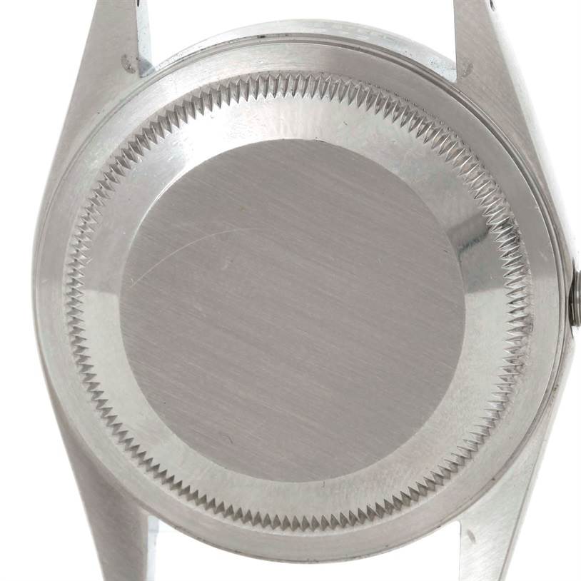 This image shows the case back of a Rolex Datejust 16220 Men's Stainless Steel Beige Dial 16220 Men's Stainless Steel Beige Dial watch from a top-down angle.
