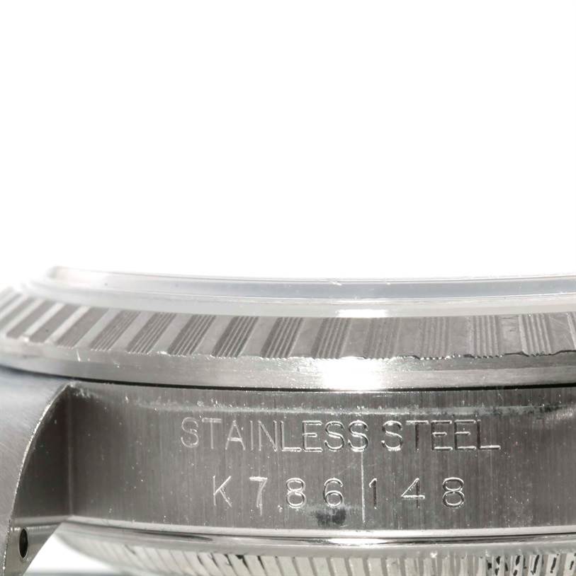 This image shows the side engravings and fluted bezel of a Rolex Datejust 16220 Men's Stainless Steel Black Dial 16220 Men's Stainless Steel Black Dial watch.