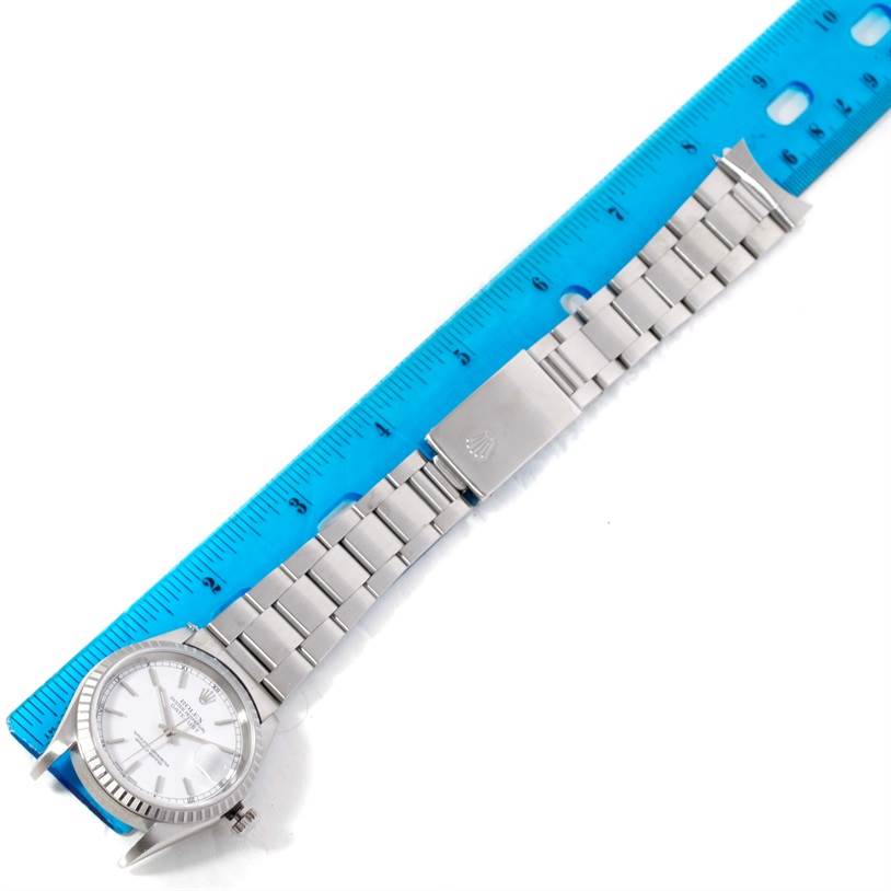 This image shows a Rolex Datejust 16220 Men's Stainless Steel Black Dial 16220 Men's Stainless Steel Black Dial watch, with a focus on the full length of its bracelet and dial, measured alongside a blue ruler.