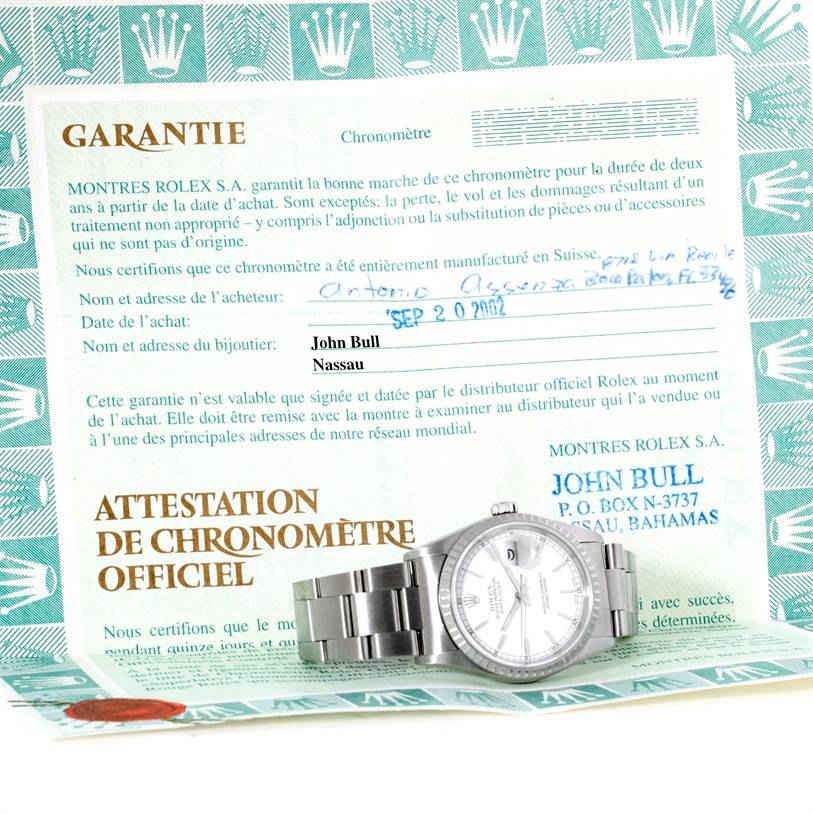 The image shows a Rolex Datejust 16220 Men's Stainless Steel Black Dial 16220 Men's Stainless Steel Black Dial watch placed on its warranty certificate, viewed from the front at a slight angle.