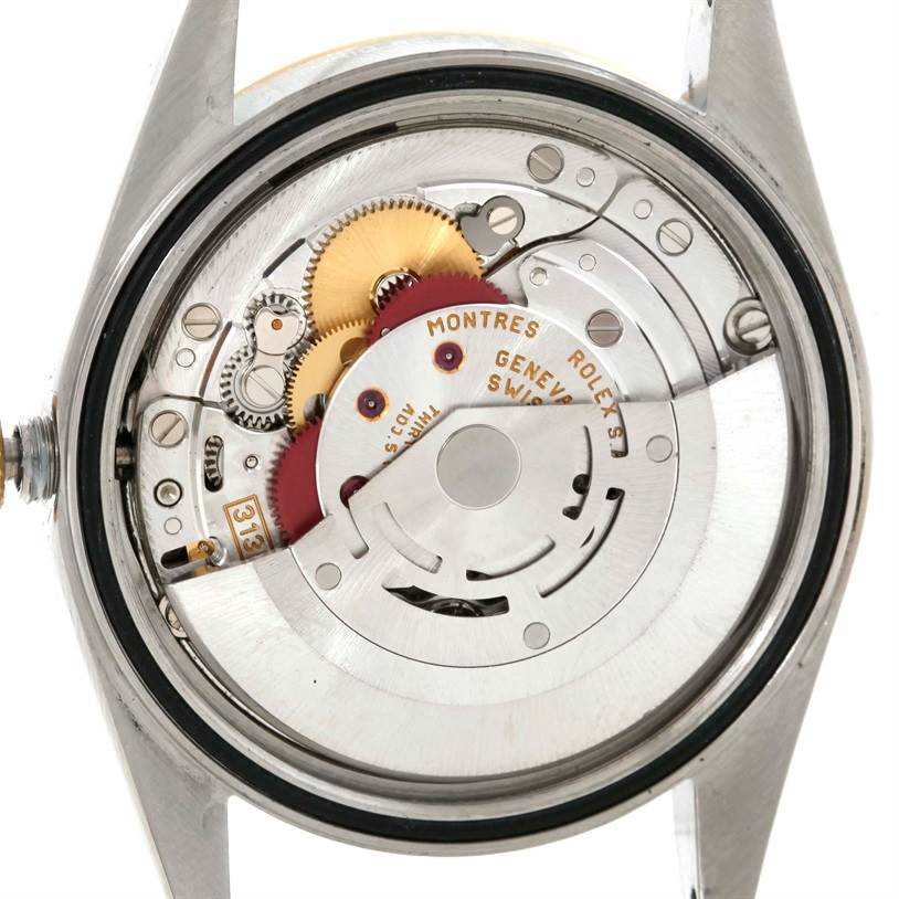 This image shows the internal mechanism of a Rolex Datejust 16233 Men's Steel and Gold (two tone) Silver Dial 16233 Men's Steel and Gold (two tone) Silver Dial watch from a rear view, displaying gears and the movement parts.