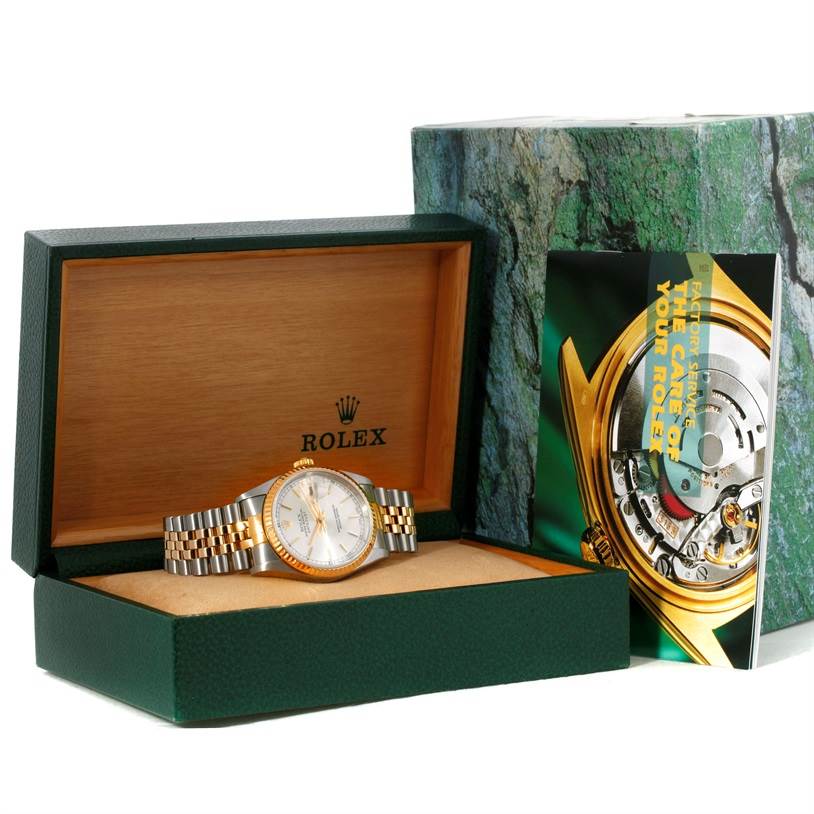 The image shows a Rolex Datejust 16233 Men's Steel and Gold (two tone) Silver Dial 16233 Men's Steel and Gold (two tone) Silver Dial watch inside its open green and wooden box, alongside its outer packaging and booklet.