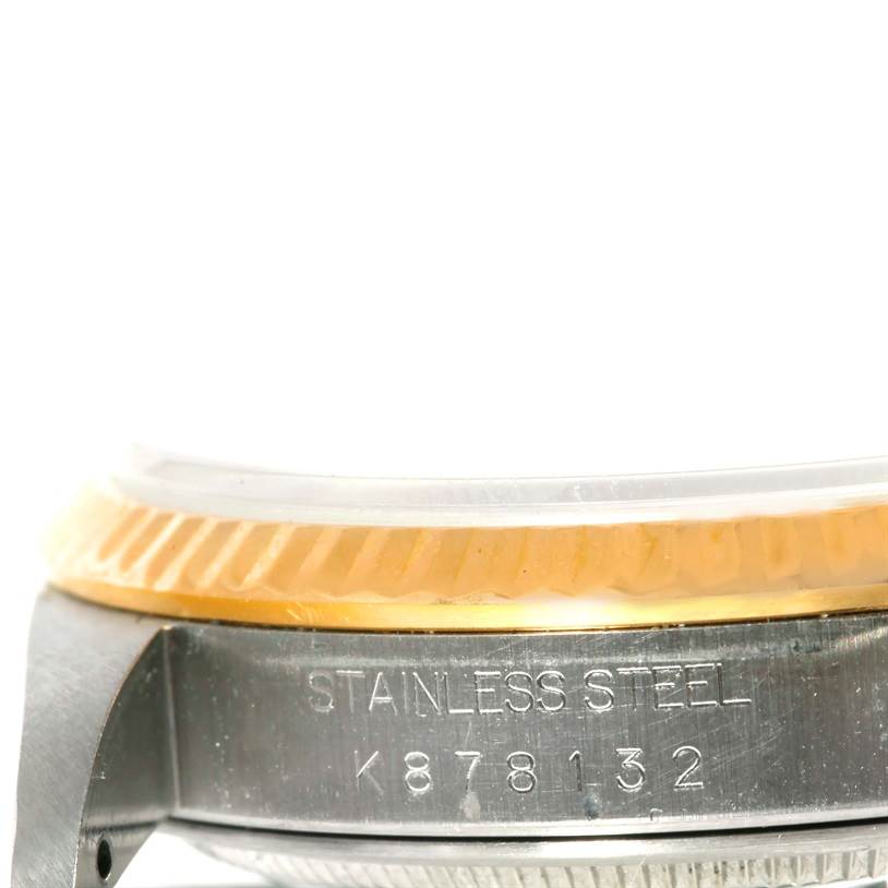This close-up angle shows the side of a Rolex Datejust 16233 Men's Steel and Gold (two tone) Silver Dial 16233 Men's Steel and Gold (two tone) Silver Dial watch, highlighting the case, bezel, and part of the serial number.