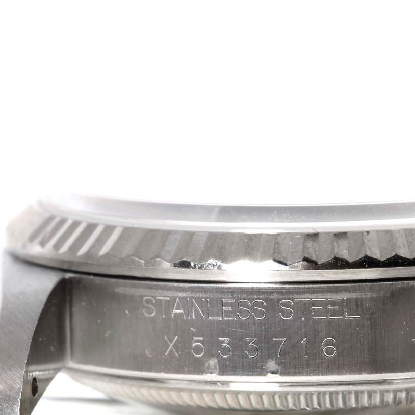 This image shows a close-up side view of the stainless steel case of a Rolex Datejust 16234 Men's Stainless Steel Silver Dial 16234 Men's Stainless Steel Silver Dial watch, highlighting the bezel and serial number.