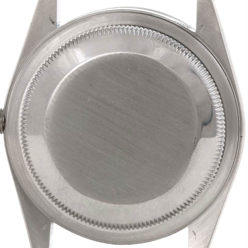 This image depicts the back casing of a Rolex Datejust 16220 Men's Stainless Steel Silver Dial 16220 Men's Stainless Steel Silver Dial watch from a top-down angle.