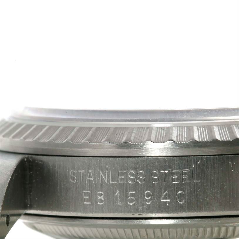 This image shows a close-up of the side of a Rolex Datejust 16220 Men's Stainless Steel Silver Dial 16220 Men's Stainless Steel Silver Dial watch, focusing on the bezel and stainless steel engraving.