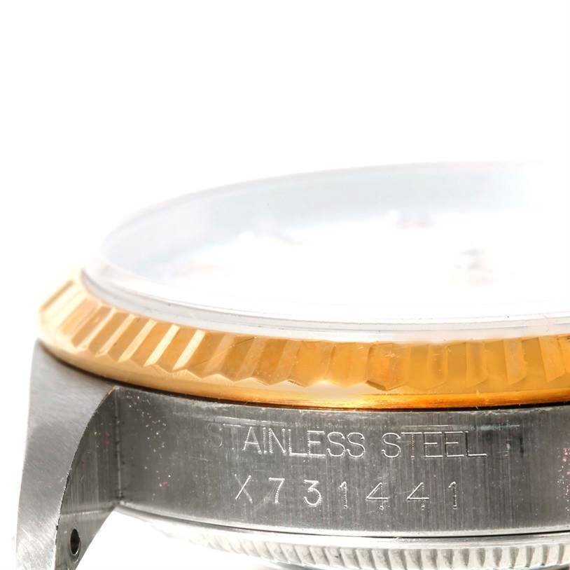 This image shows a close-up of the stainless steel case and gold fluted bezel of a Rolex Datejust 16233 Men's Steel and Gold (two tone) White Dial 16233 Men's Steel and Gold (two tone) White Dial watch, focusing on the serial number.