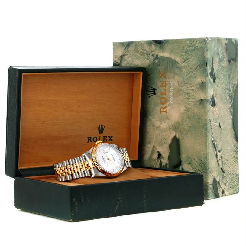 The Rolex Datejust 16233 Men's Steel and Gold (two tone) White Dial 16233 Men's Steel and Gold (two tone) White Dial watch is displayed in an open box, showing its face, bezel, and bracelet at an angle.
