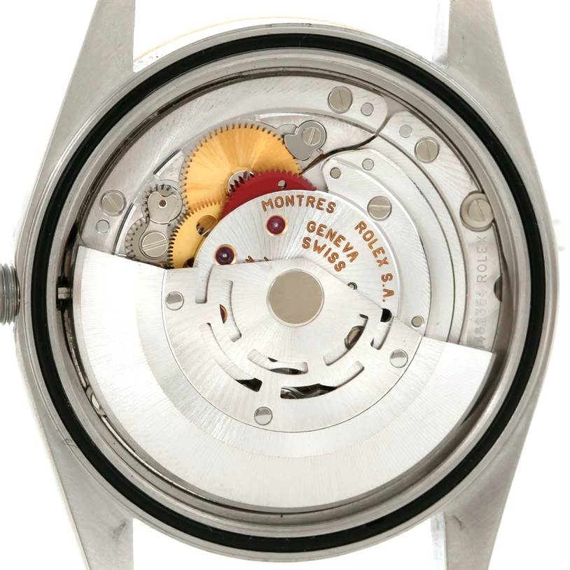 The image shows the internal mechanical movement of a Rolex Datejust 16233 Men's Steel and Gold (two tone) Champagne Dial 16233 Men's Steel and Gold (two tone) Champagne Dial watch from a rear view angle, highlighting its intricate gears and components.