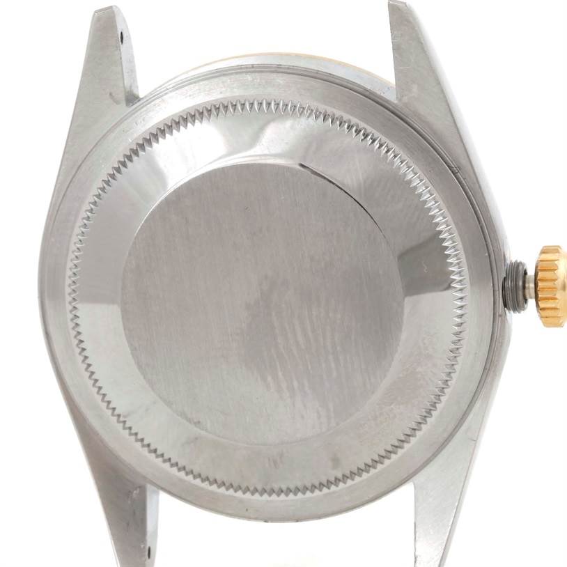 The image shows the back of a Rolex Datejust 16233 Men's Steel and Gold (two tone) Champagne Dial 16233 Men's Steel and Gold (two tone) Champagne Dial watch case with its screw-down case back and crown.