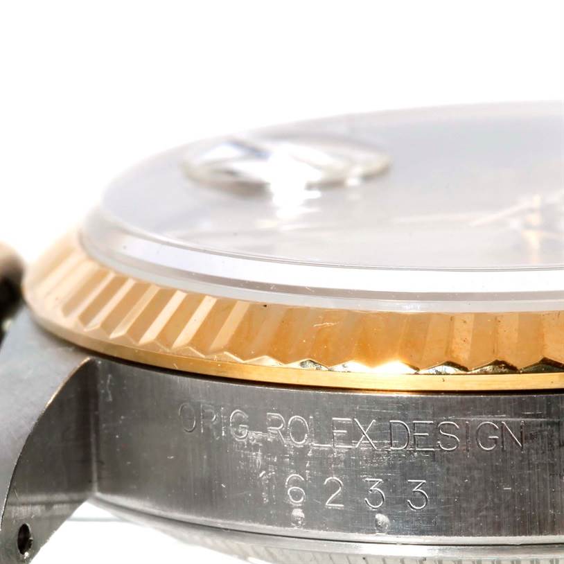 The image shows a close-up of the side of a Rolex Datejust 16233 Men's Steel and Gold (two tone) Champagne Dial 16233 Men's Steel and Gold (two tone) Champagne Dial watch, highlighting its fluted bezel, case, and engraved model number.