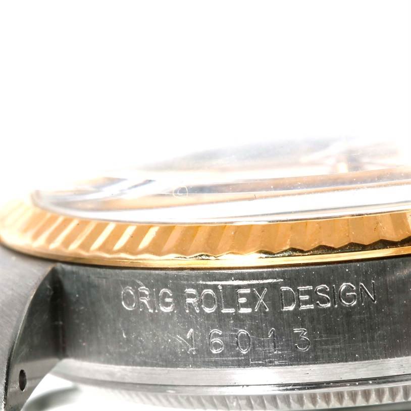 This image shows a close-up view of the side of a Rolex Datejust 16013 Men's Stainless Steel Champagne Dial 16013 Men's Stainless Steel Champagne Dial watch, highlighting the engraved model number and part of the bezel.