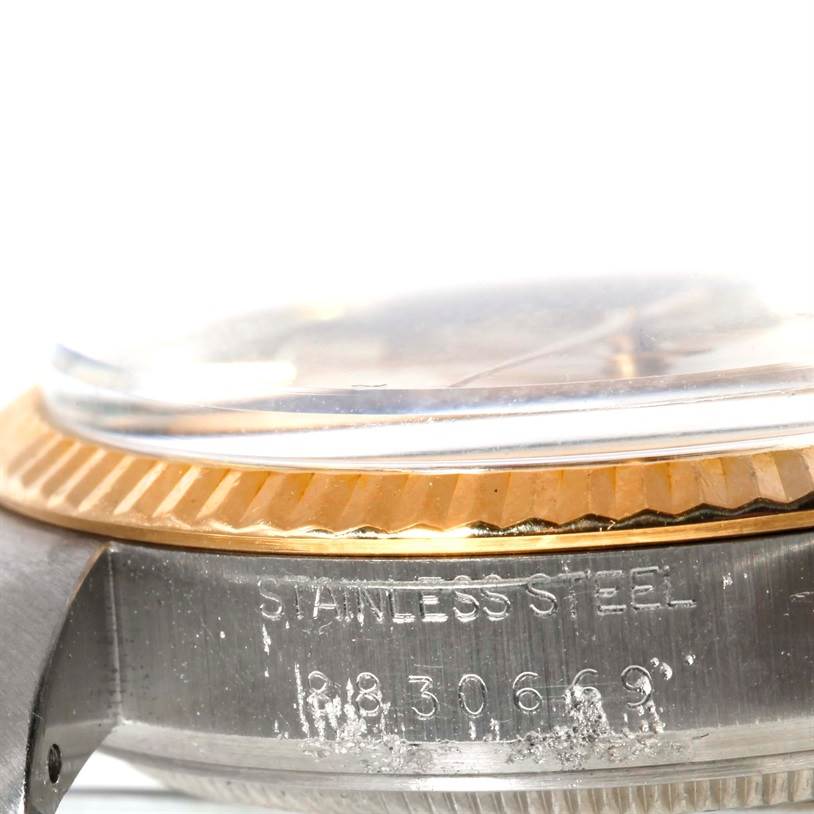 The image shows a close-up side view of the case and bezel of a Rolex Datejust 16013 Men's Stainless Steel Champagne Dial 16013 Men's Stainless Steel Champagne Dial watch, including the serial number and "STAINLESS STEEL" engraving.
