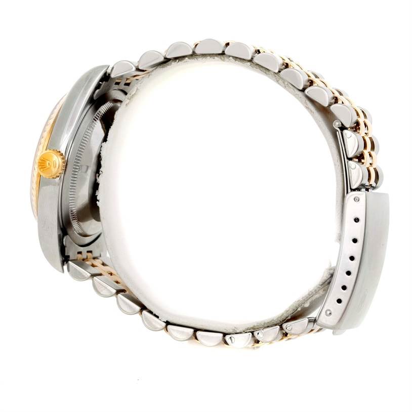 The image shows a side view of a Rolex Datejust 16233 Men's Steel and Gold (two tone) Champagne Dial 16233 Men's Steel and Gold (two tone) Champagne Dial watch, highlighting its crown, case, and bracelet.