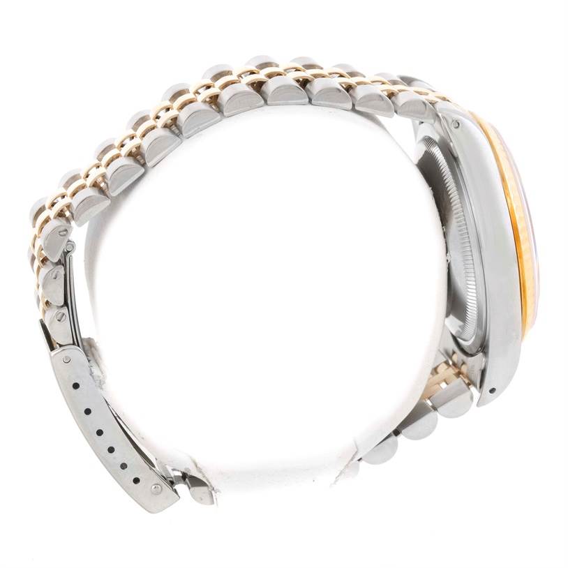 This side-angle view of the Rolex Datejust 16233 Men's Steel and Gold (two tone) Champagne Dial 16233 Men's Steel and Gold (two tone) Champagne Dial watch displays its bracelet and part of the case.