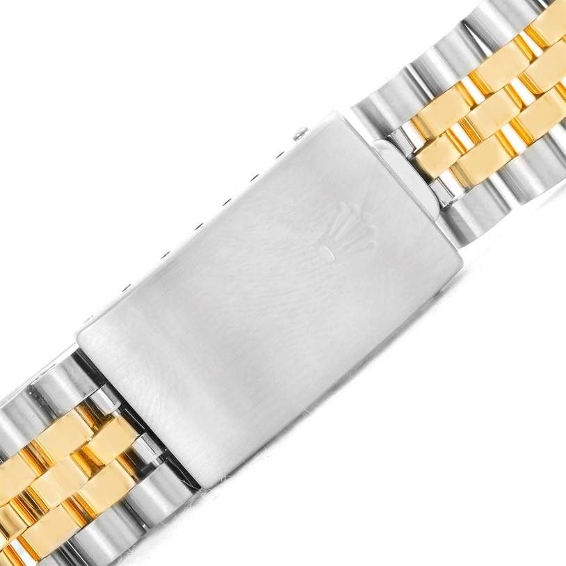 This image shows a close-up of the clasp and part of the two-tone bracelet of a Rolex Datejust 16233 Men's Steel and Gold (two tone) Champagne Dial 16233 Men's Steel and Gold (two tone) Champagne Dial watch.