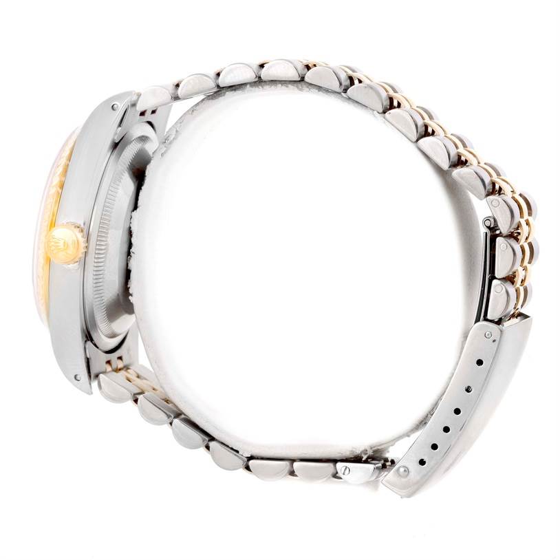 This side view of the Rolex Datejust 16233 Men's Steel and Gold (two tone) Champagne Dial 16233 Men's Steel and Gold (two tone) Champagne Dial watch shows the crown, case side, and a part of the bracelet.