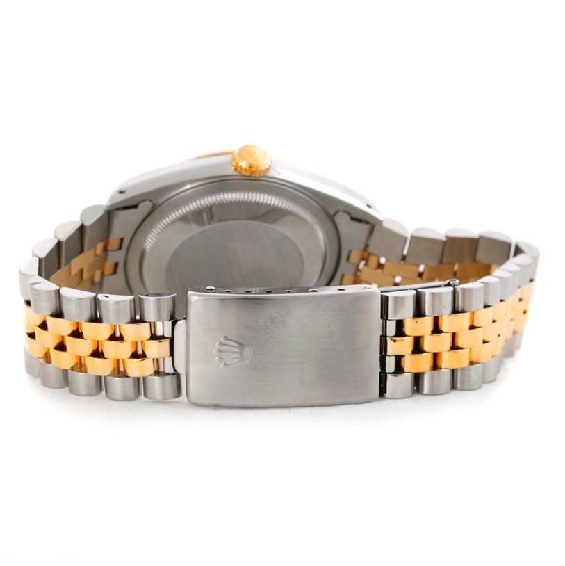 This image shows the backside of the Rolex Datejust 16233 Men's Steel and Gold (two tone) Silver Dial 16233 Men's Steel and Gold (two tone) Silver Dial, highlighting the clasp and bracelet with a two-tone design.