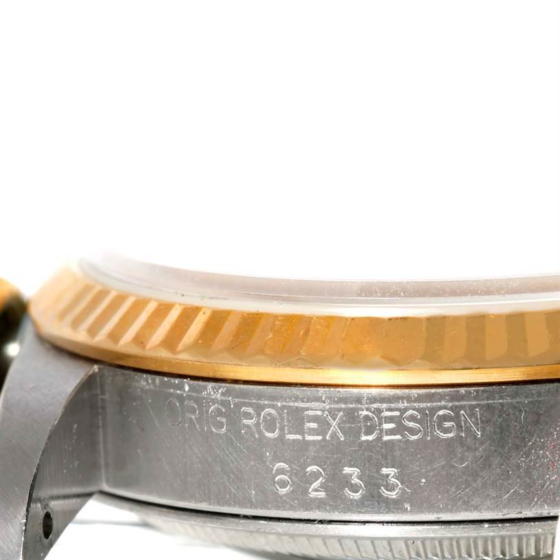 The image shows a close-up of the side of a Rolex Datejust 16233 Men's Steel and Gold (two tone) Champagne Dial 16233 Men's Steel and Gold (two tone) Champagne Dial watch, focusing on the engraved model number and part of the fluted bezel.