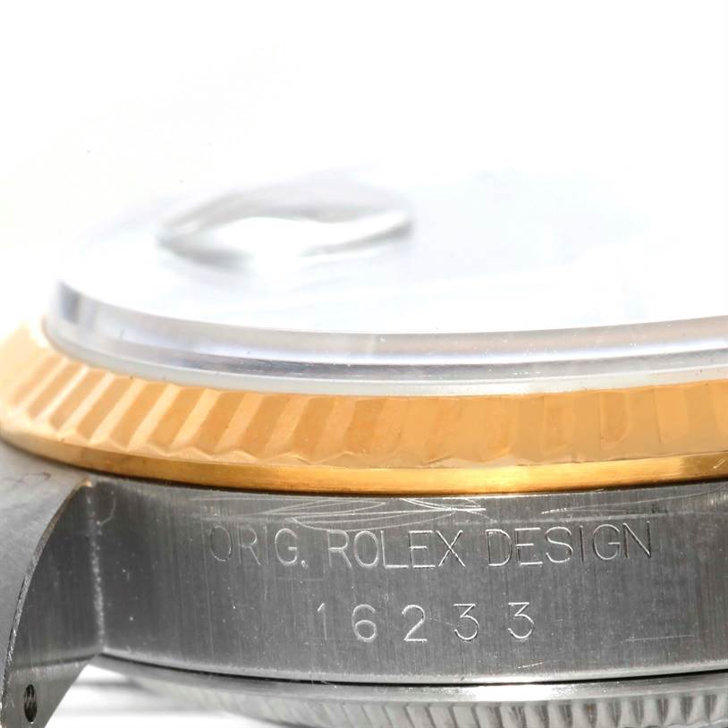 This image shows a close-up side view of a Rolex Datejust 16233 Men's Steel and Gold (two tone) Blue Dial 16233 Men's Steel and Gold (two tone) Blue Dial watch, highlighting the bezel and part of the case with model number 16233.