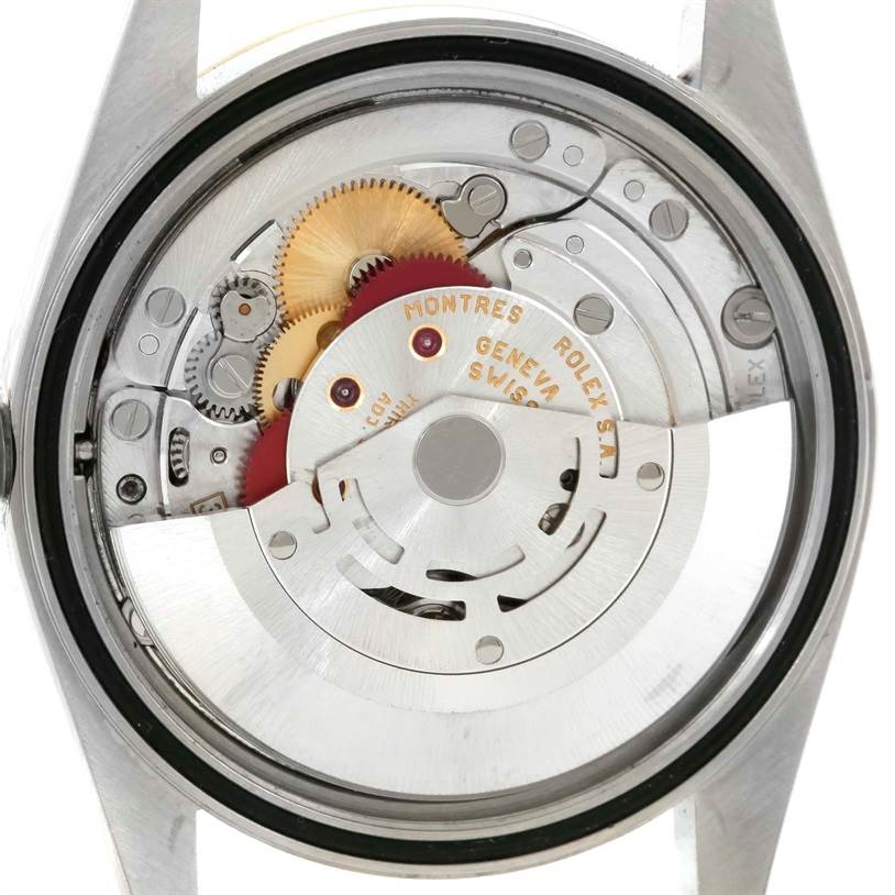 This image shows the internal mechanism of a Rolex Datejust 16233 Men's Steel and Gold (two tone) Champagne Dial 16233 Men's Steel and Gold (two tone) Champagne Dial watch from a back angle, highlighting the gears and rotor.