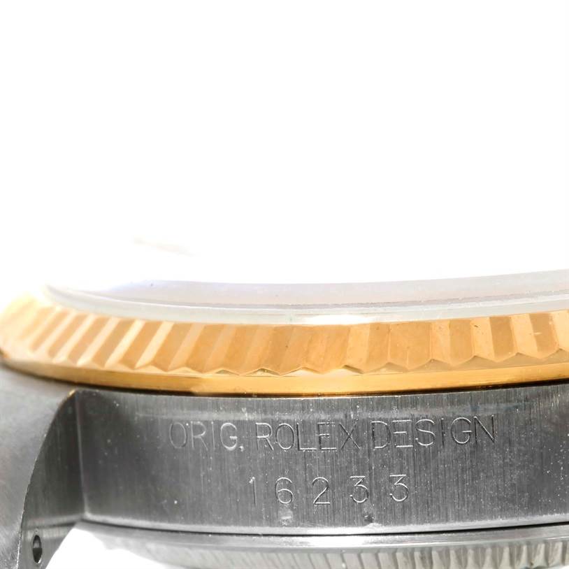 The image shows a side view of the Rolex Datejust 16233 Men's Steel and Gold (two tone) Champagne Dial 16233 Men's Steel and Gold (two tone) Champagne Dial watch, highlighting the bezel and case with the model number 16233 visible.