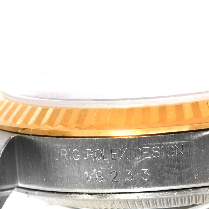 The image shows a close-up view of the side of a Rolex Datejust 16233 Men's Steel and Gold (two tone) Black Dial 16233 Men's Steel and Gold (two tone) Black Dial watch case, highlighting the "Orig Rolex Design" engraving and part of the bezel.
