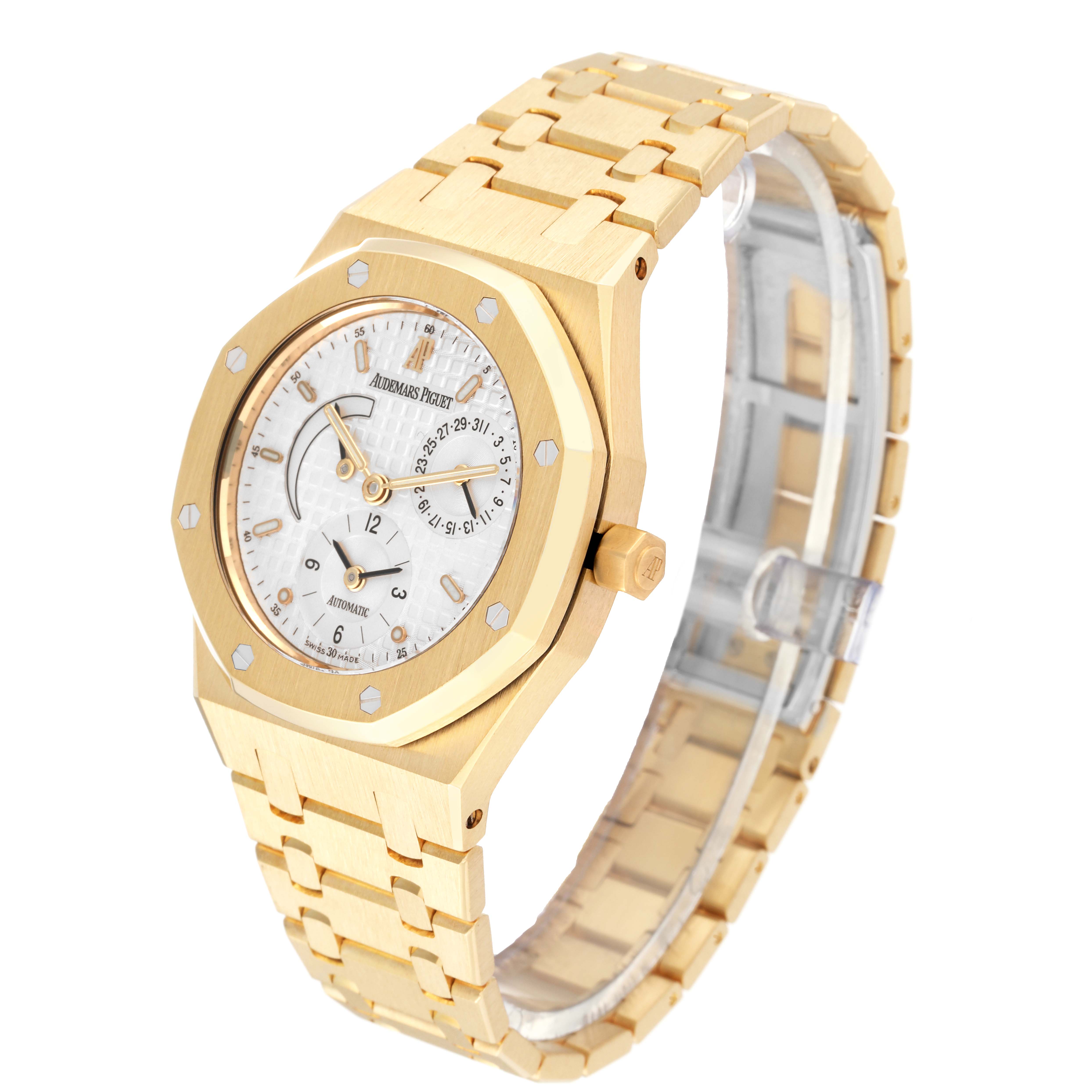 The image shows a side-angle view of an Audemars Piguet Royal Oak 25730BA.OO.0789BA Men's Yellow Gold Silver Dial 25730BA.OO.0789BA Men's Yellow Gold Silver Dial watch highlighting its gold bracelet and detailed dial.
